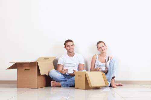 Movers carrying furniture from a flat in Gants Hill